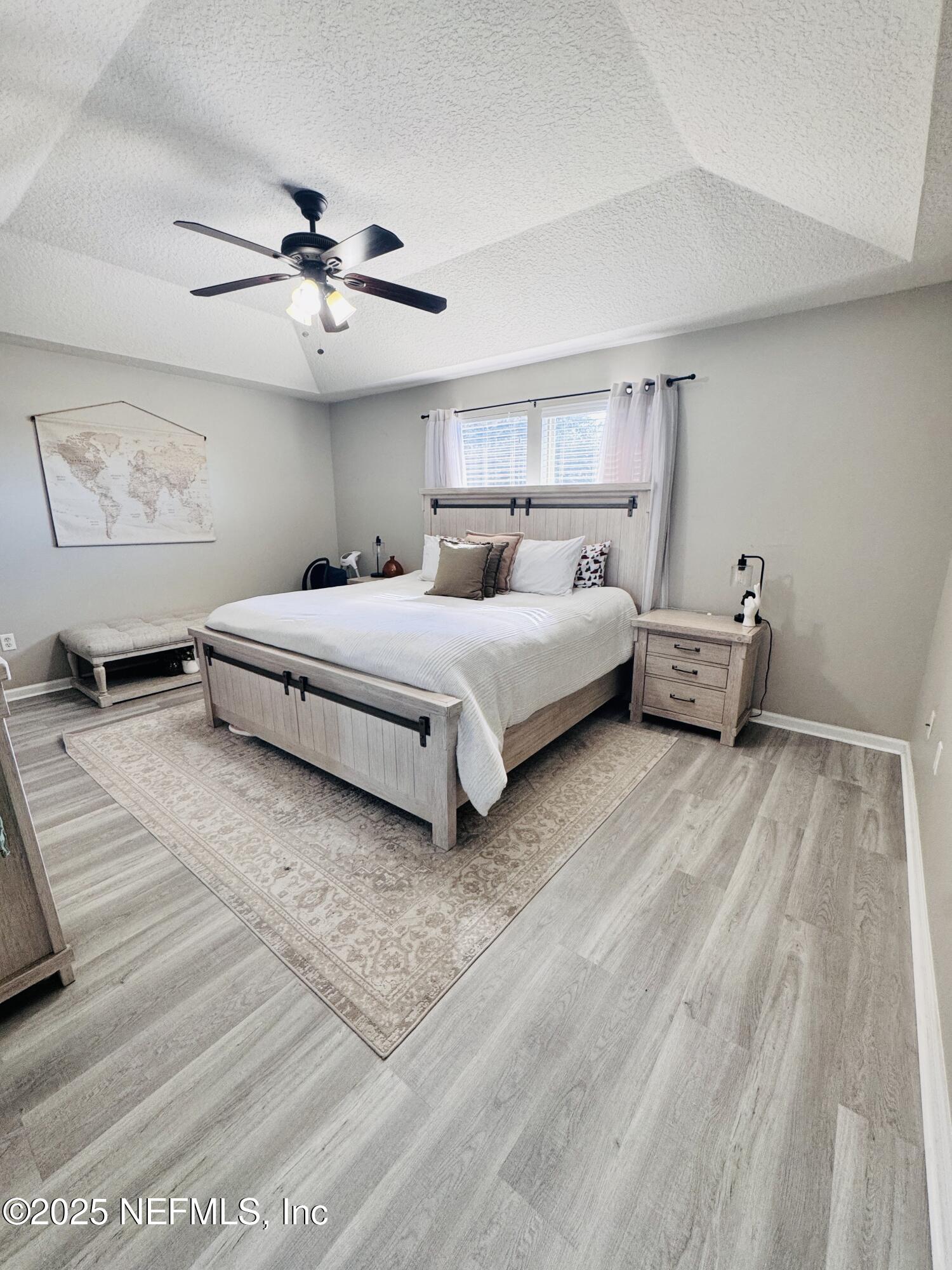8882 Shell Island Drive Jacksonville, FL 32216 - Photo 12 of 15 a spacious bedroom with a bed and ceiling fan