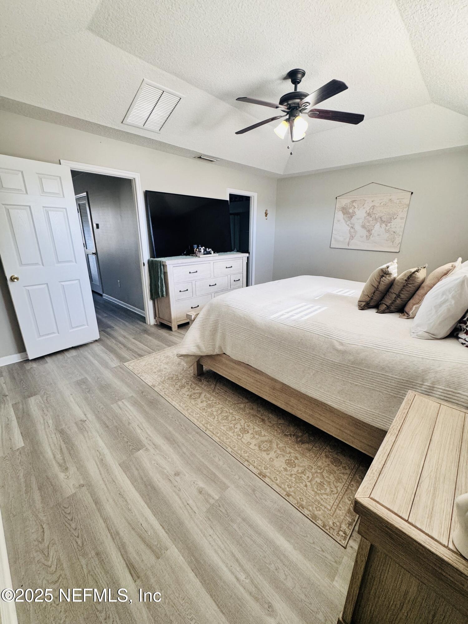 8882 Shell Island Drive Jacksonville, FL 32216 - Photo 13 of 15 a bedroom with a bed and a ceiling fan