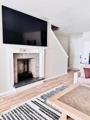 a living room with a fireplace and a rug