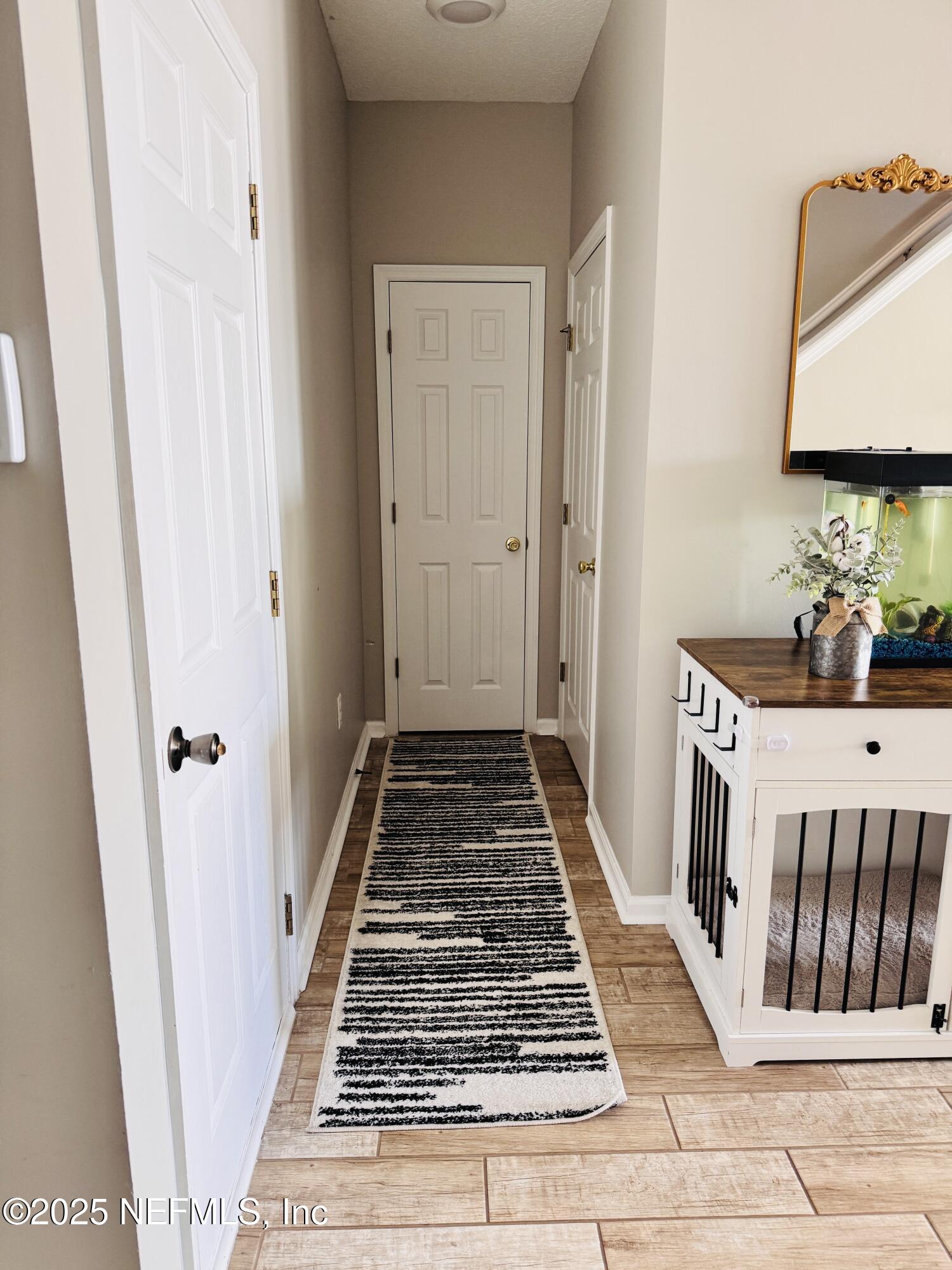 8882 Shell Island Drive Jacksonville, FL 32216 - Photo 6 of 15 a view of a hallway with wooden floor and entryway