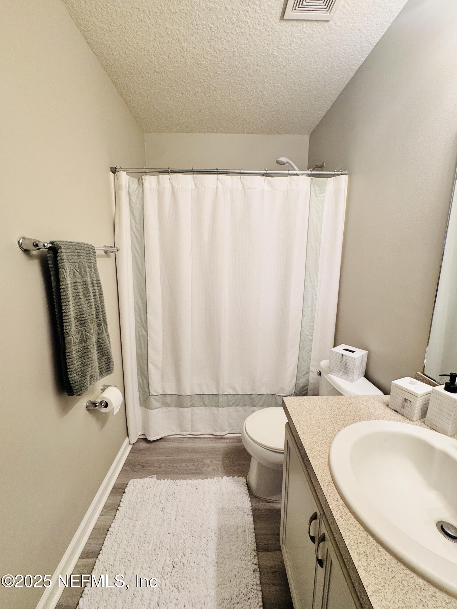 8882 Shell Island Drive Jacksonville, FL 32216 - Photo 10 of 15 a bathroom with a granite countertop sink and a mirror