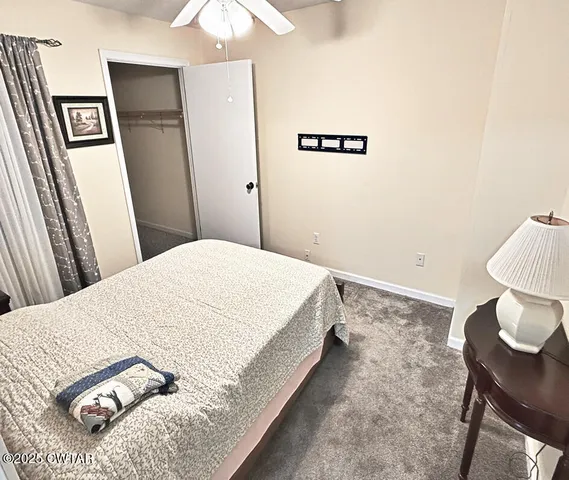 a bedroom with a bed and a table in it