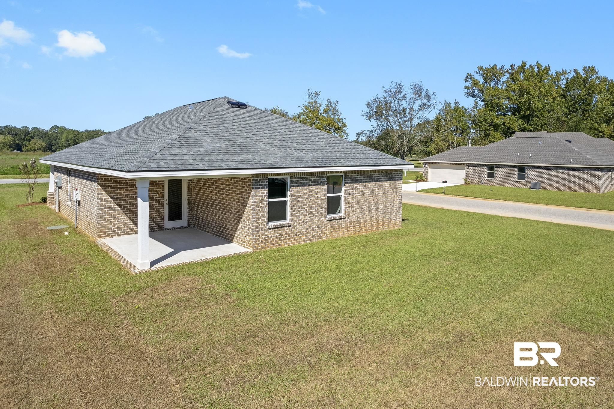 16014 Alabama Avenue Silverhill, AL 36576 - Photo 39 of 50 Rear view of property with a yard and a patio area