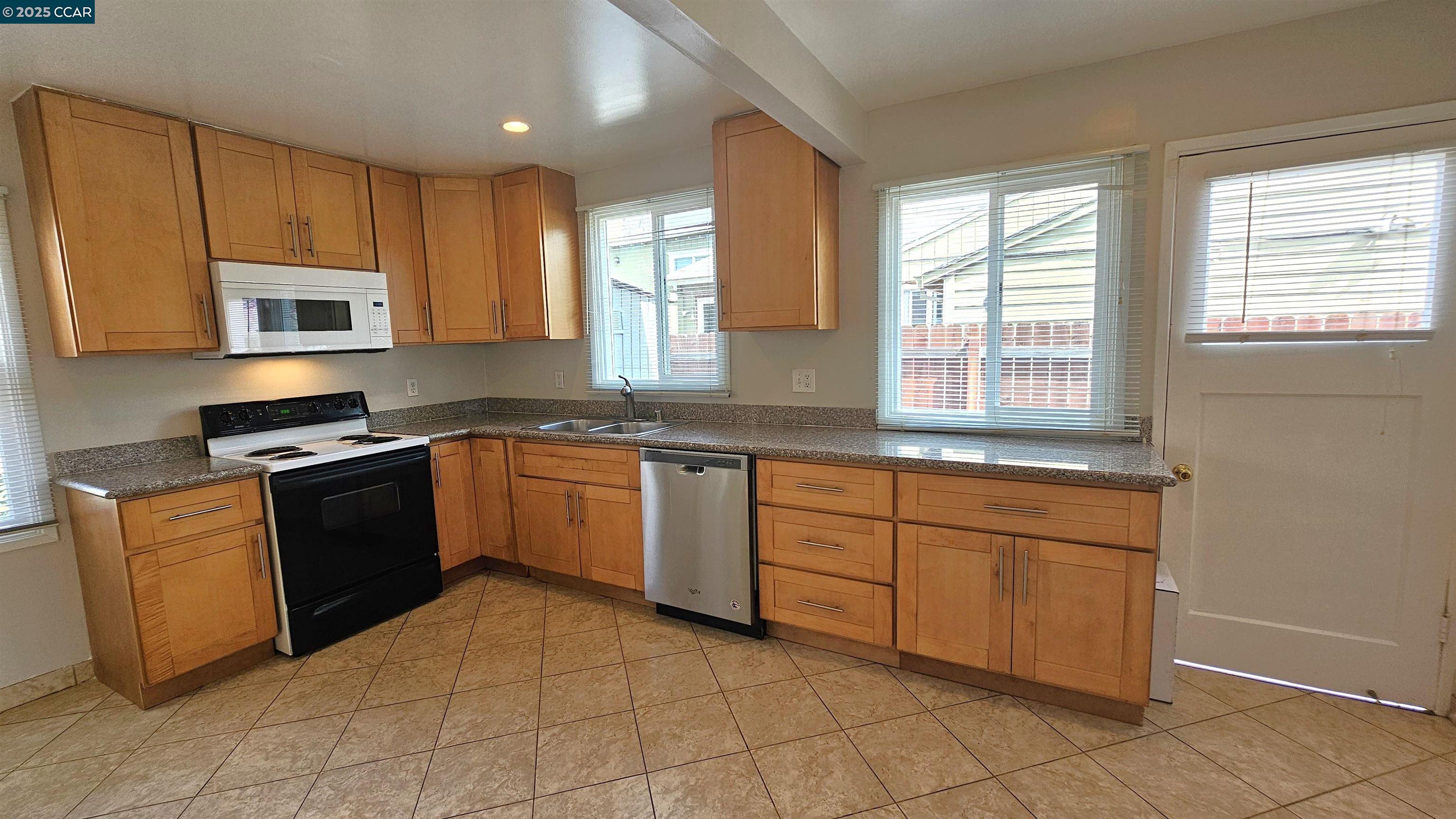 2475 Maple Avenue Concord, CA 94520 - Photo 11 of 28 a kitchen with granite countertop cabinets stainless steel appliances a sink and a window