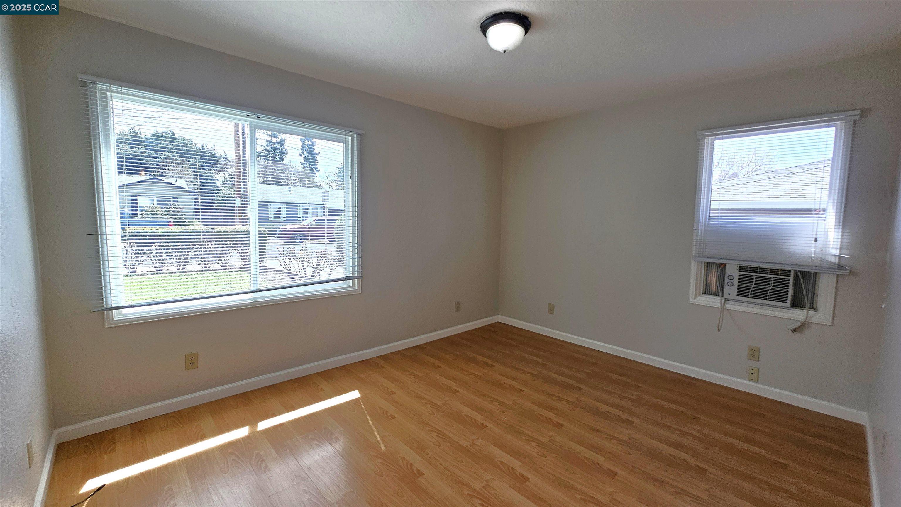 2475 Maple Avenue Concord, CA 94520 - Photo 15 of 28 a view of an empty room with wooden floor and a window