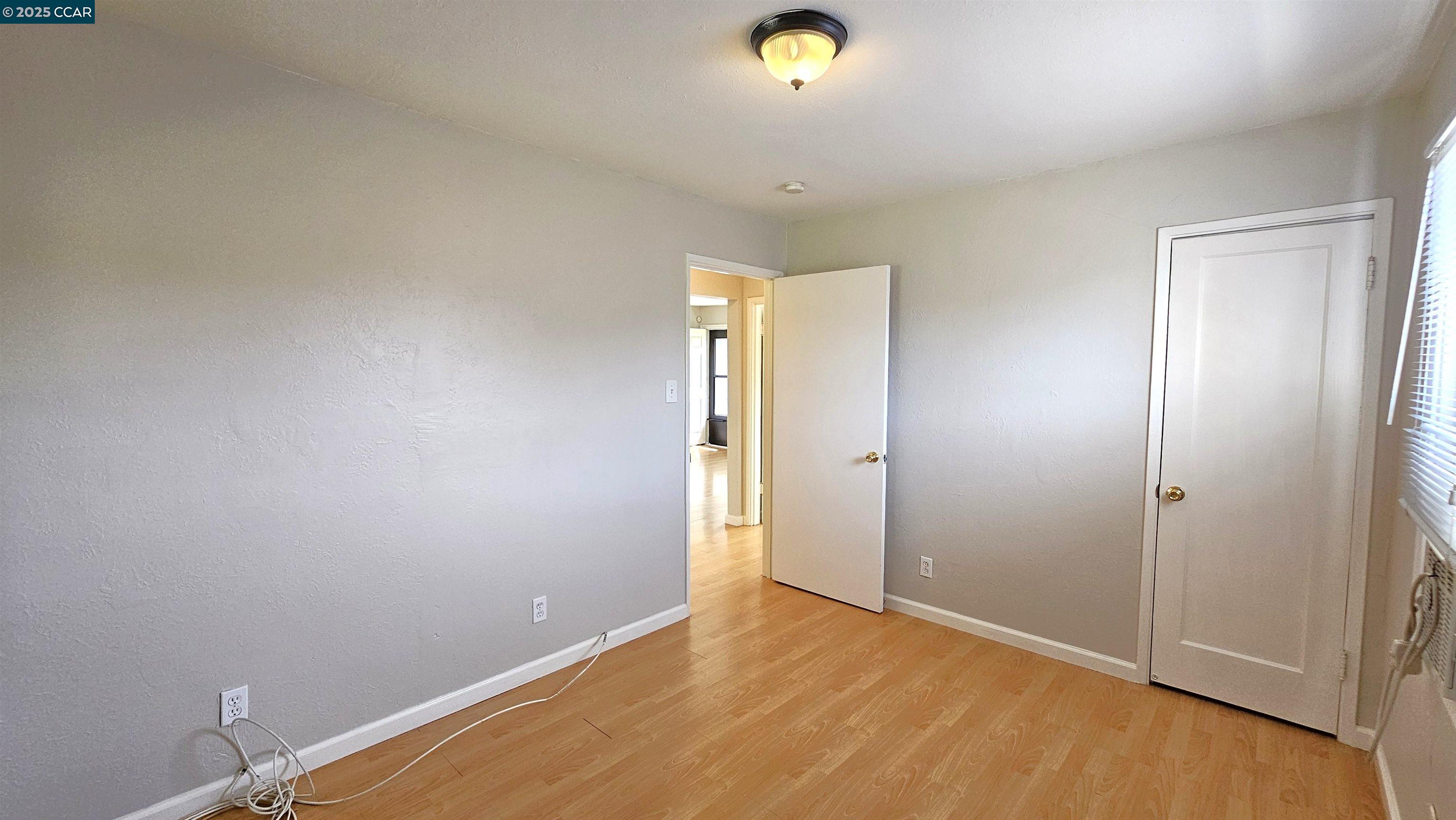 2475 Maple Avenue Concord, CA 94520 - Photo 18 of 28 an empty room with wooden floor and mirror