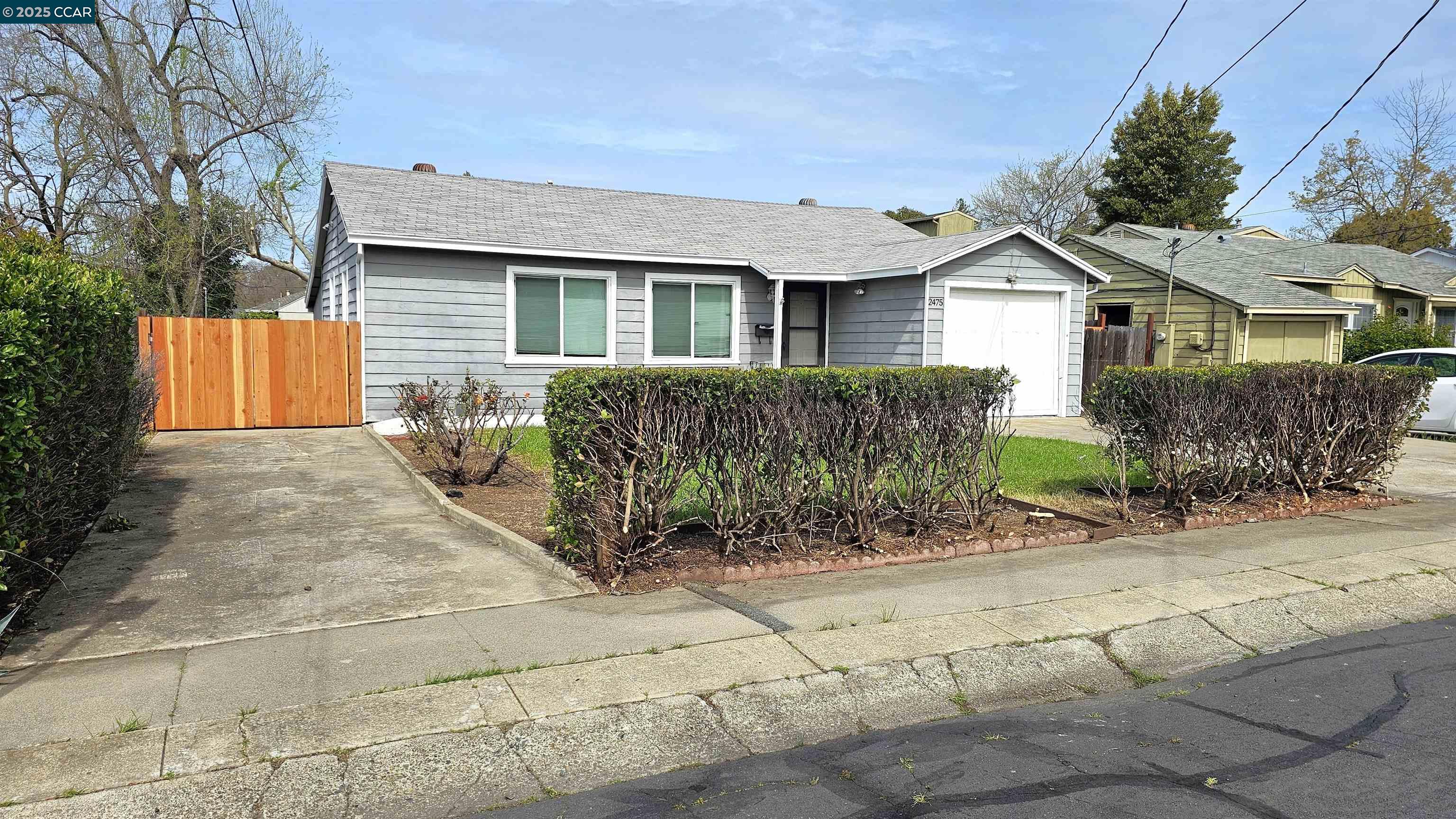2475 Maple Avenue Concord, CA 94520 - Photo 3 of 28 a front view of a house with garden
