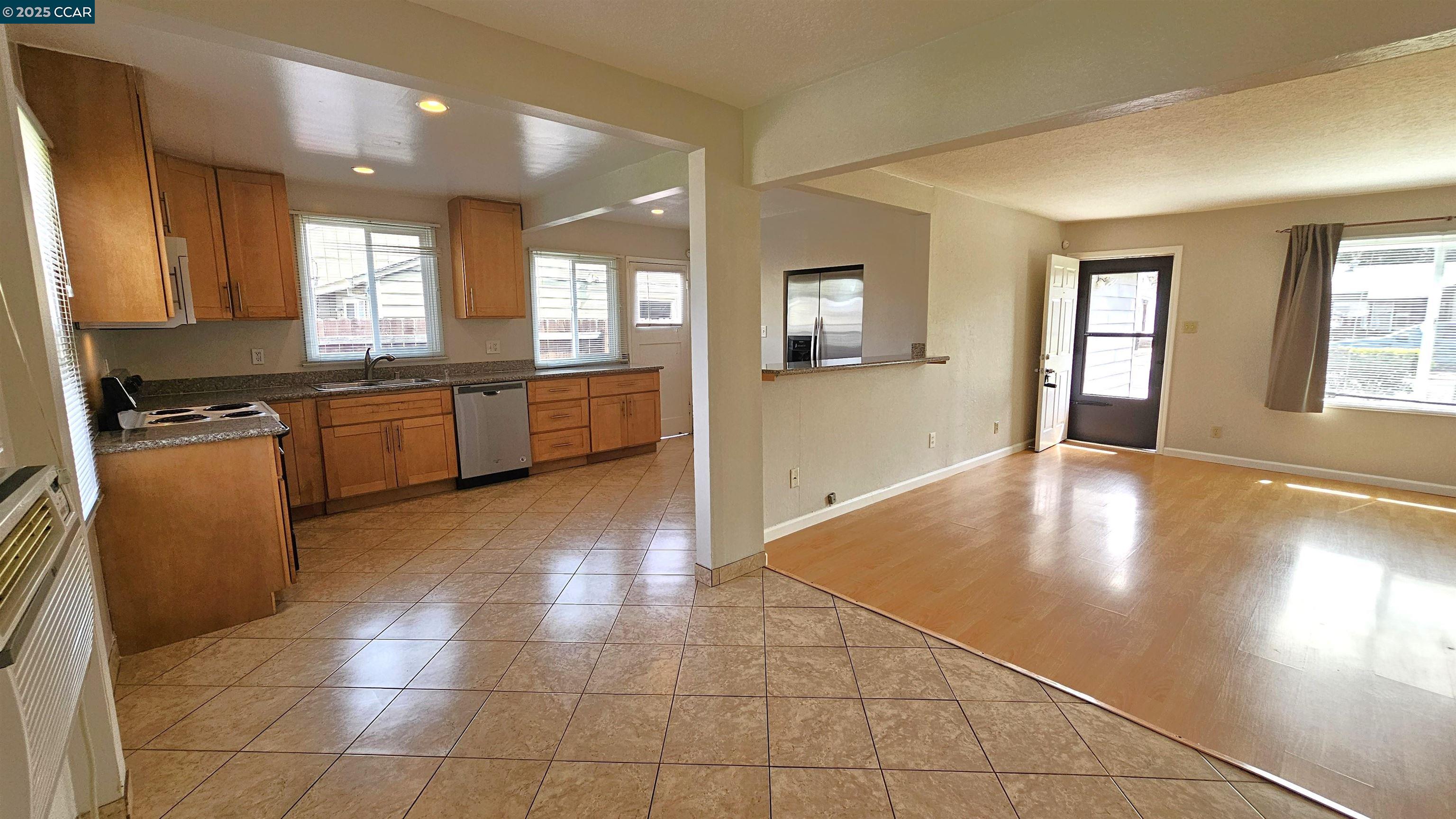 2475 Maple Avenue Concord, CA 94520 - Photo 9 of 28 a large kitchen with granite countertop a large counter top space and stainless steel appliances