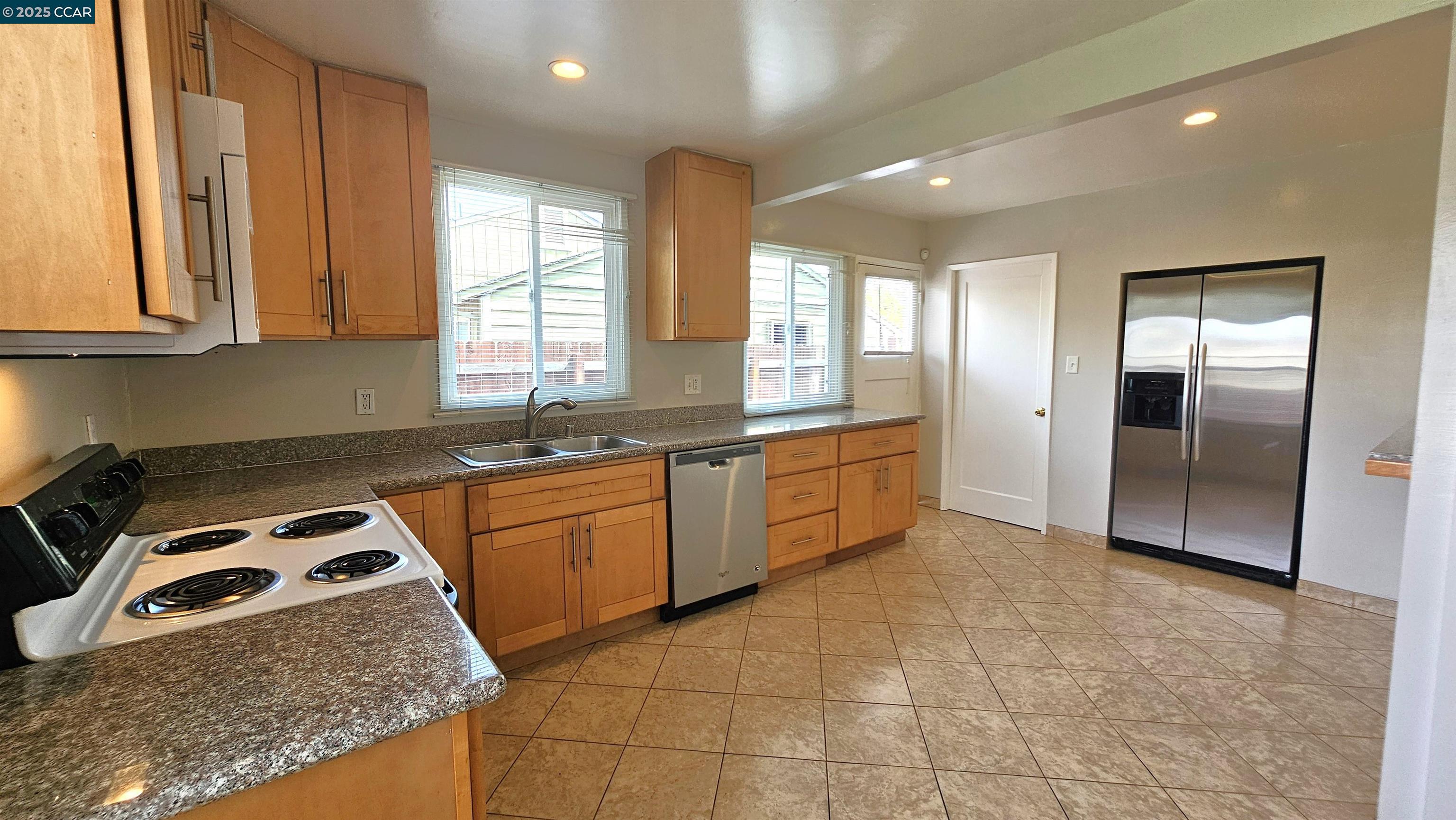 2475 Maple Avenue Concord, CA 94520 - Photo 10 of 28 a kitchen with stainless steel appliances granite countertop a sink stove and refrigerator