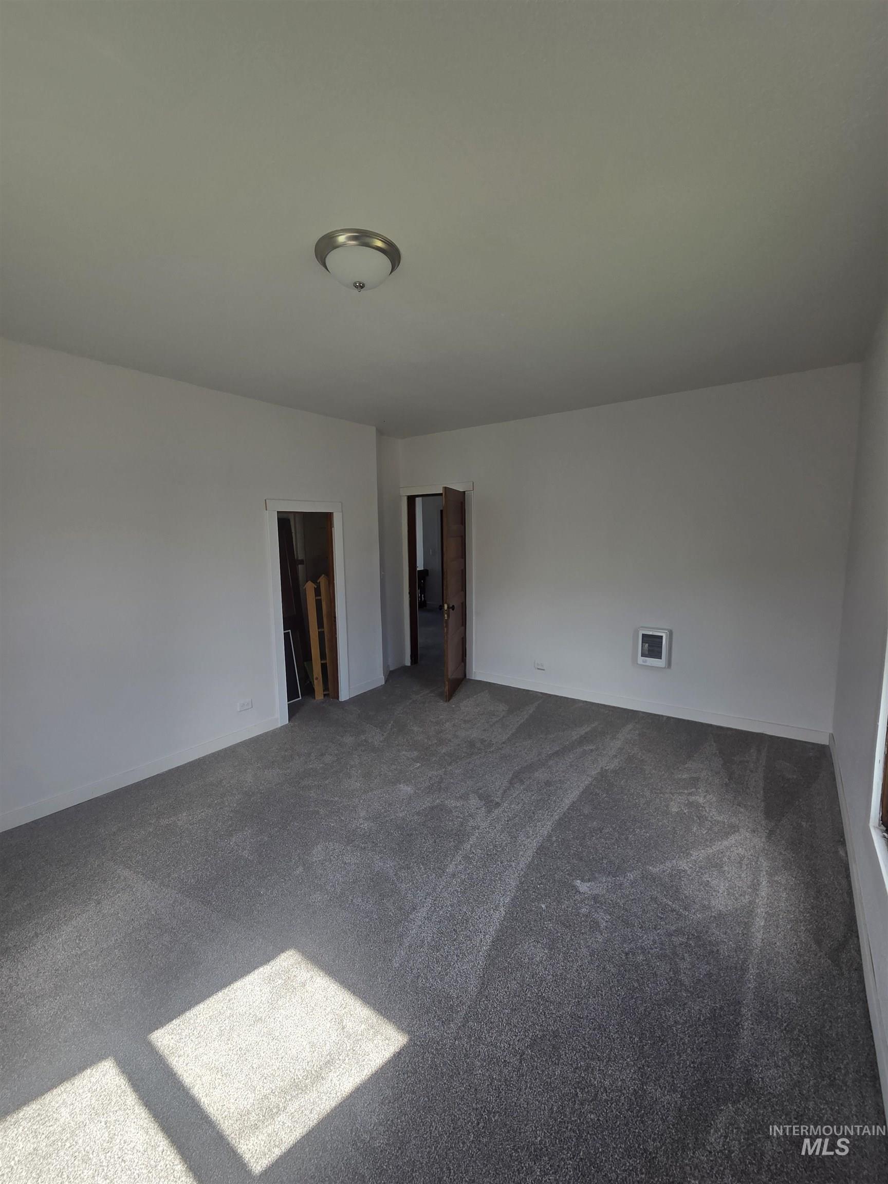 986 Columbia Street Pomeroy, WA 99347 - Photo 15 of 20 Spacious interior room with gray wall-to-wall carpeting and neutral white walls