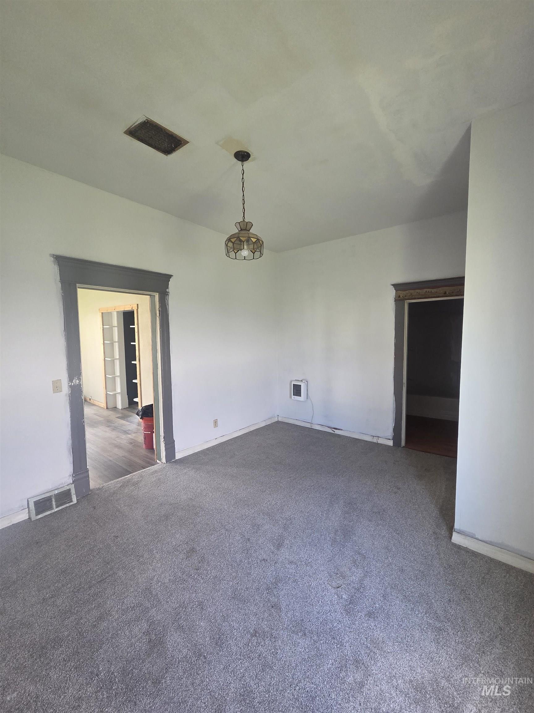 986 Columbia Street Pomeroy, WA 99347 - Photo 6 of 20 Spacious interior room featuring light gray carpeting, white walls, and dark gray trim around door frames