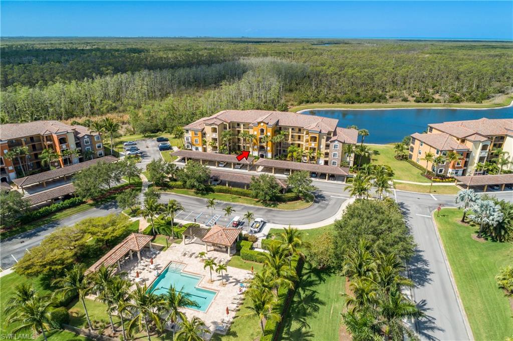 9719 Acqua Court, Unit 214 Naples, FL 34113 - Photo 1 of 50 a view of a lake with a yard