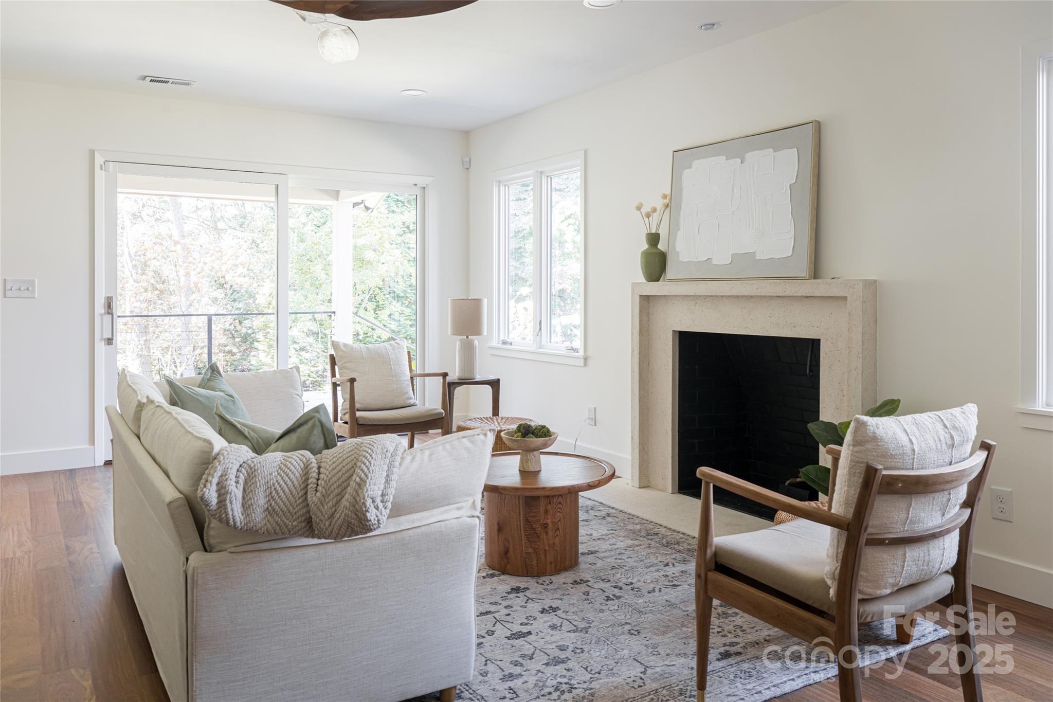 5 Holly Hill Road Asheville, NC 28803 - Photo 14 of 33 a living room with furniture potted plant and a fireplace