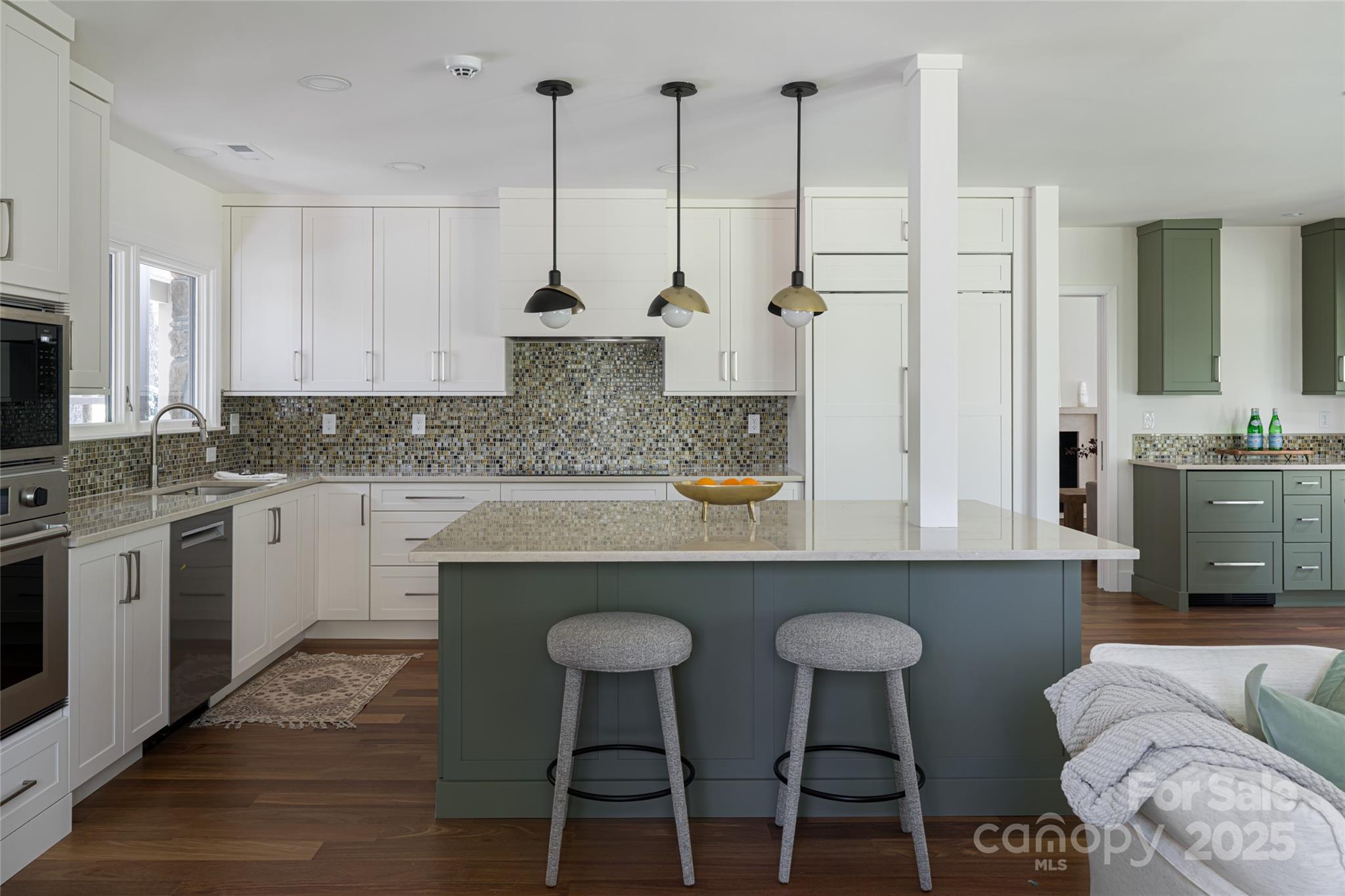 5 Holly Hill Road Asheville, NC 28803 - Photo 18 of 33 a kitchen with stainless steel appliances granite countertop a table chairs sink and cabinets