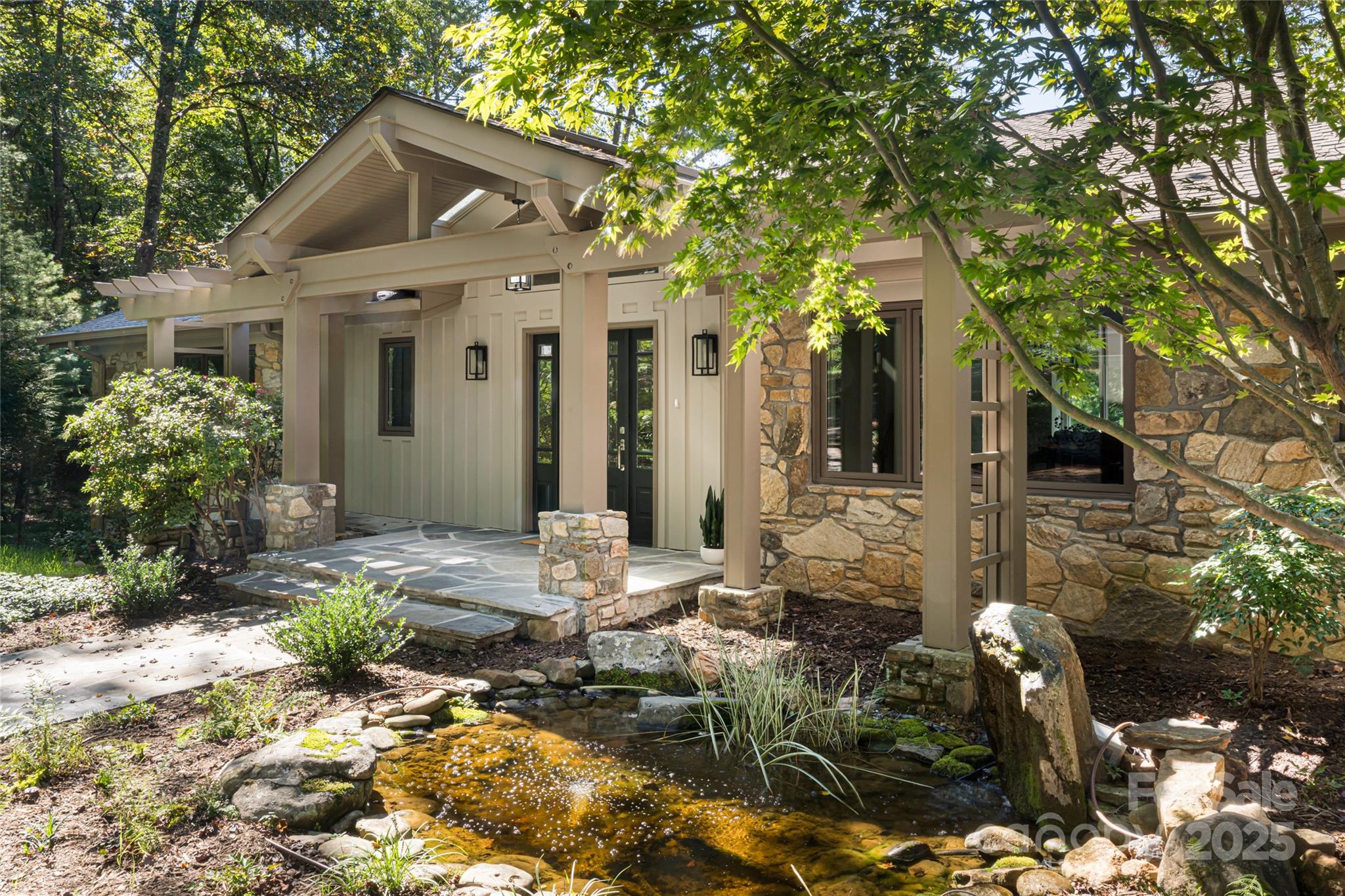 5 Holly Hill Road Asheville, NC 28803 - Photo 2 of 33 a front view of house with yard outdoor seating and covered with trees