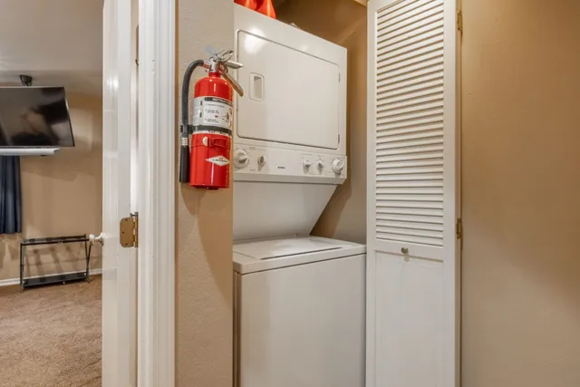 a spacious bedroom with a bed and glass window