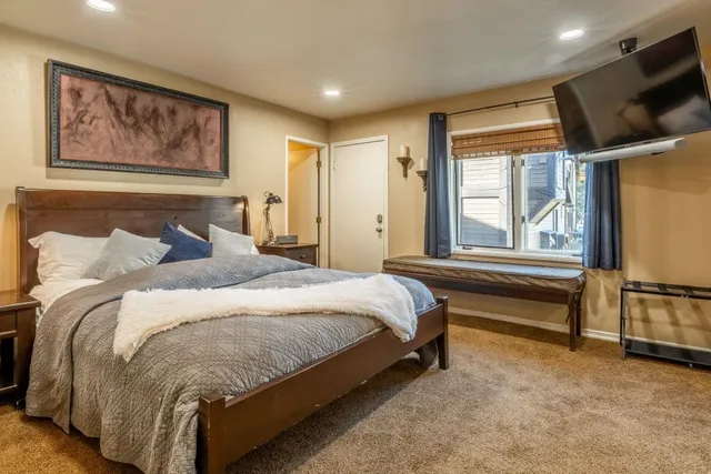 a bedroom with a bed couch and a window