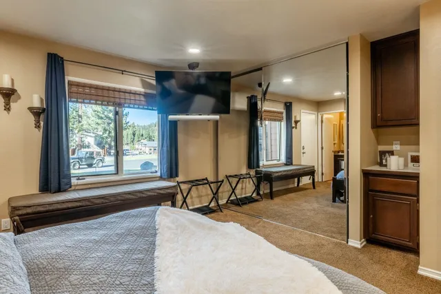 a bedroom with a bed and a desk