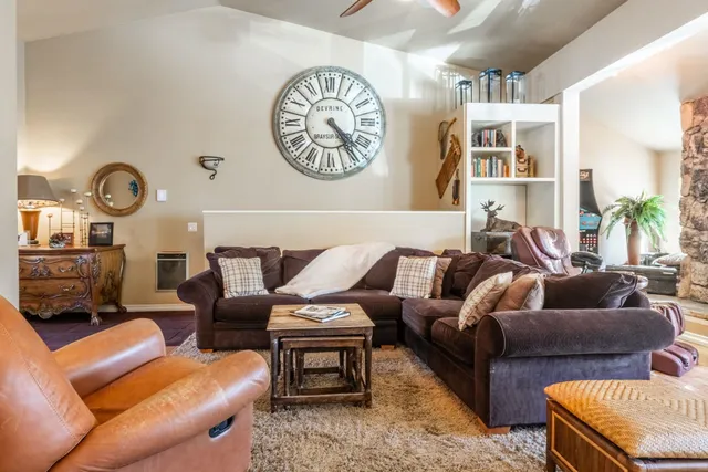 a living room with furniture and a clock
