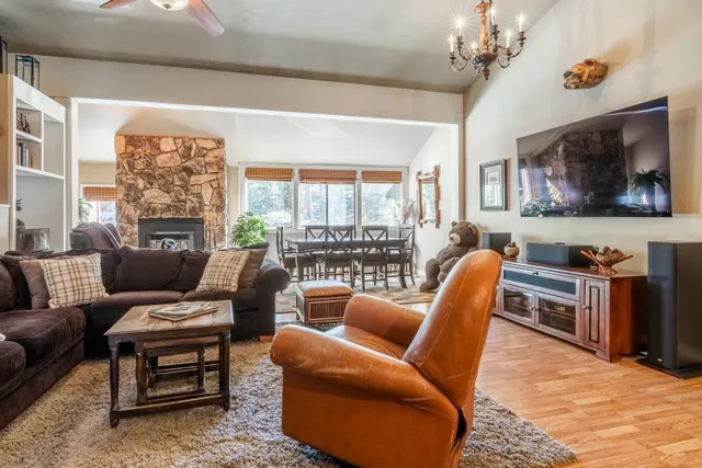 a living room with furniture a flat screen tv and a window