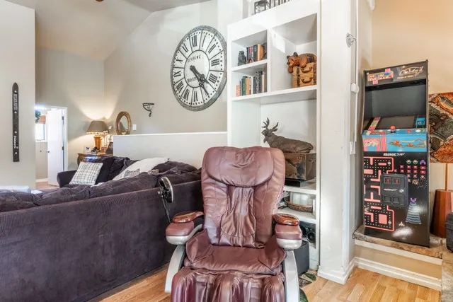 a living room with furniture and a bookshelf