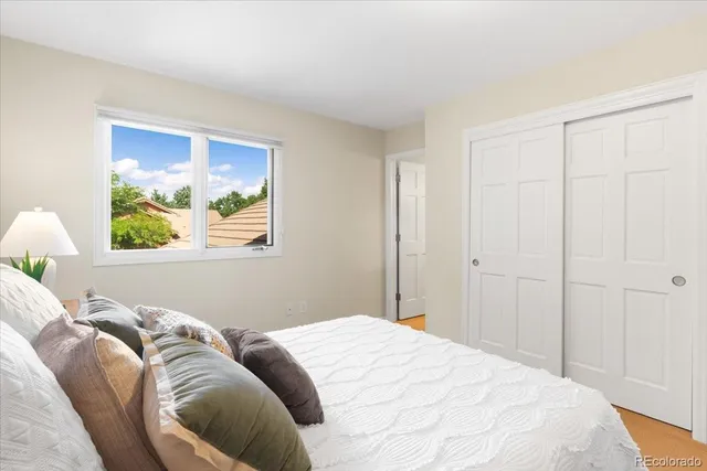 a bedroom with a bed and a painting on the wall