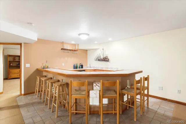 a kitchen with a dining table chairs and large window