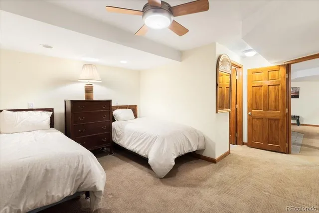 a bedroom with two beds and painted walls