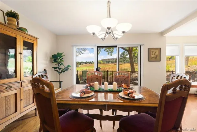 a view of a dining room with furniture wooden floor and chandelier
