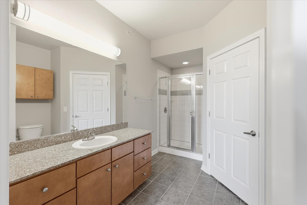 2502 Leon Street, Unit 414 Austin, TX 78705 - Photo 19 of 21 a bathroom with a granite countertop sink mirror and double
