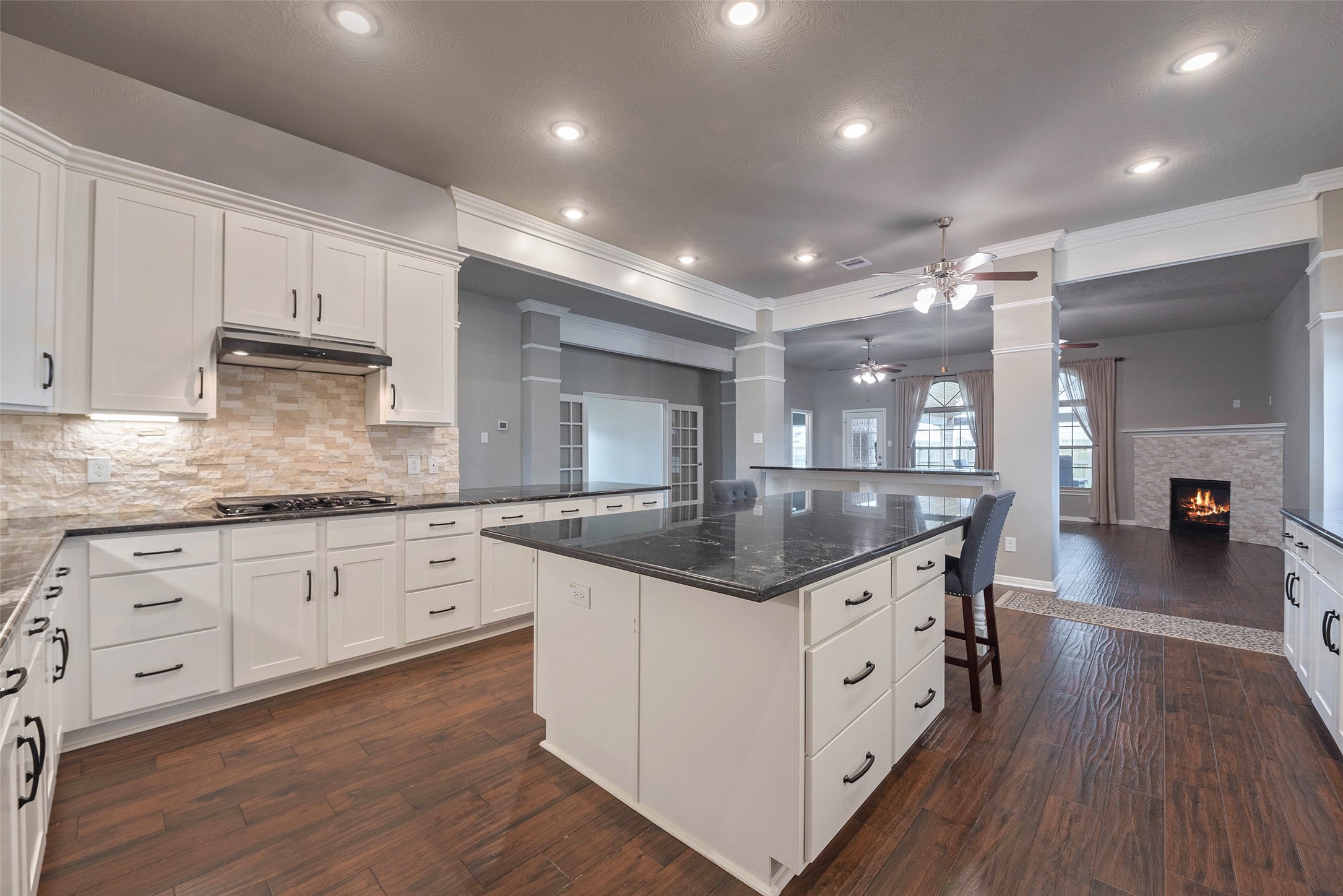 3705 Cabo Road League City, TX 77573 - Photo 11 of 43 a kitchen with granite countertop white cabinets and wooden floor