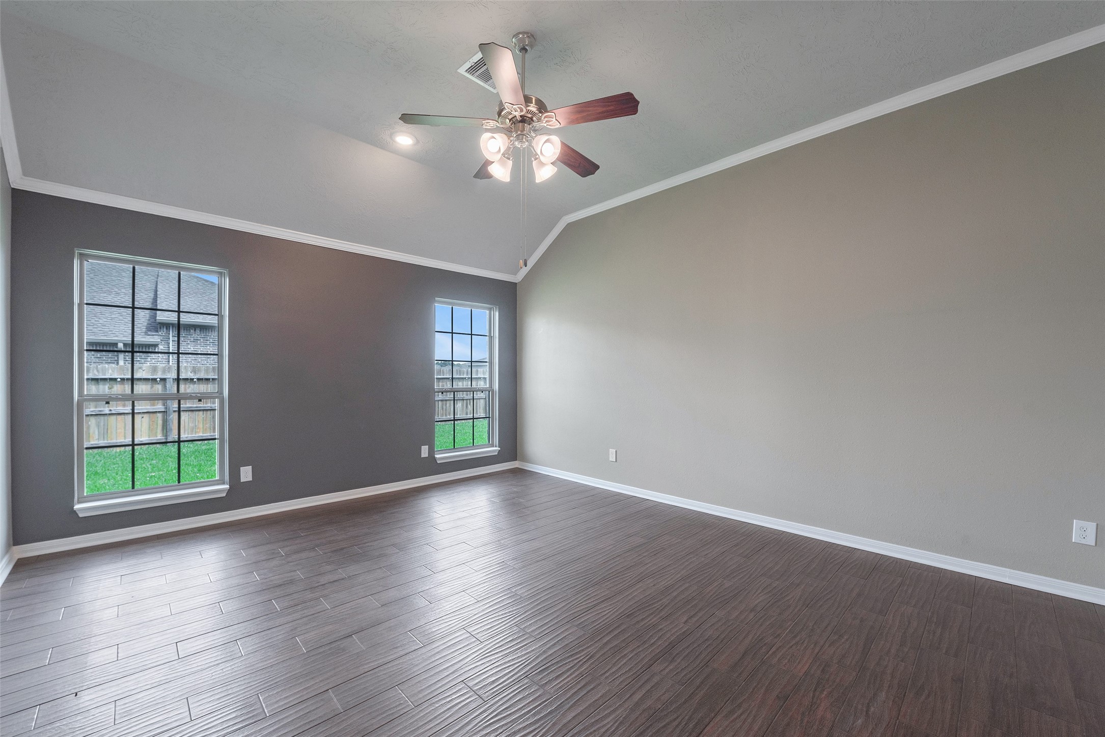 3705 Cabo Road League City, TX 77573 - Photo 14 of 43 an empty room with wooden floor chandelier fan and windows