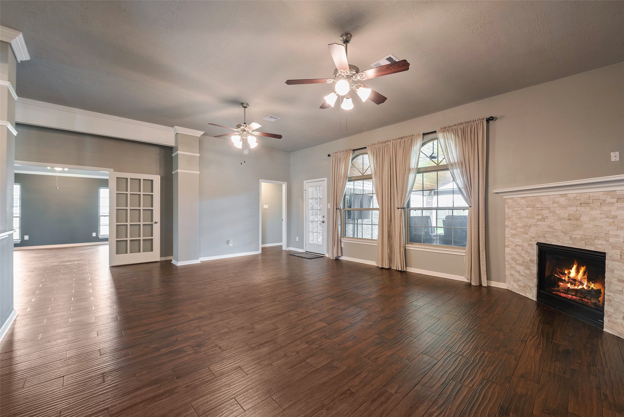 3705 Cabo Road League City, TX 77573 - Photo 7 of 43 a view of an empty room with wooden floor and a fireplace