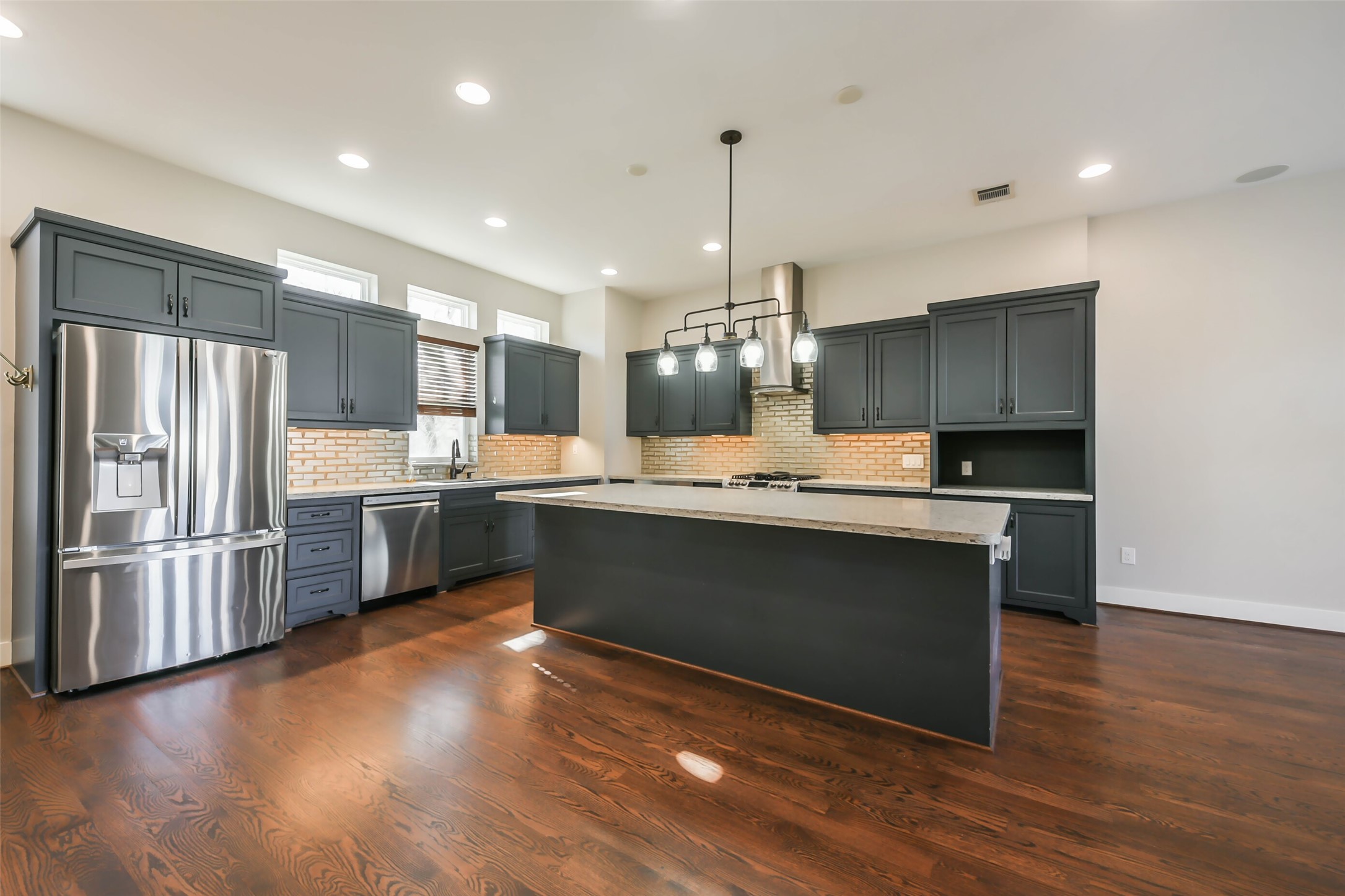 2422 Hadley Street Houston, TX 77004 - Photo 11 of 50 a large kitchen with granite countertop a large counter top stainless steel appliances and cabinets