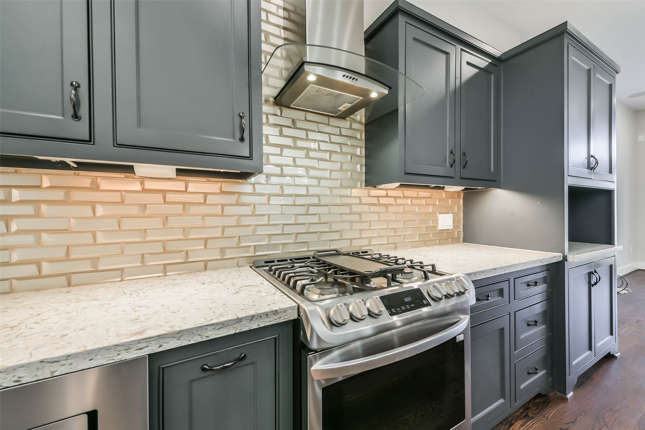 2422 Hadley Street Houston, TX 77004 - Photo 14 of 50 a kitchen with granite countertop cabinets stove top oven and microwave