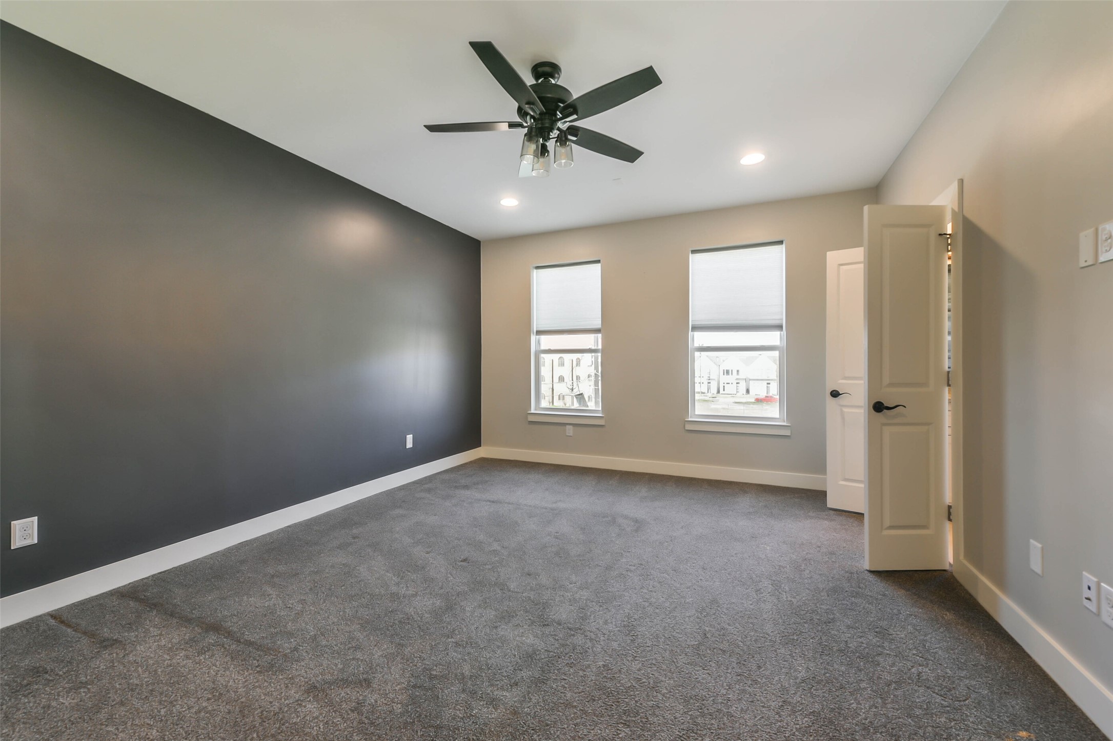 2422 Hadley Street Houston, TX 77004 - Photo 31 of 50 an empty room with windows and ceiling fan