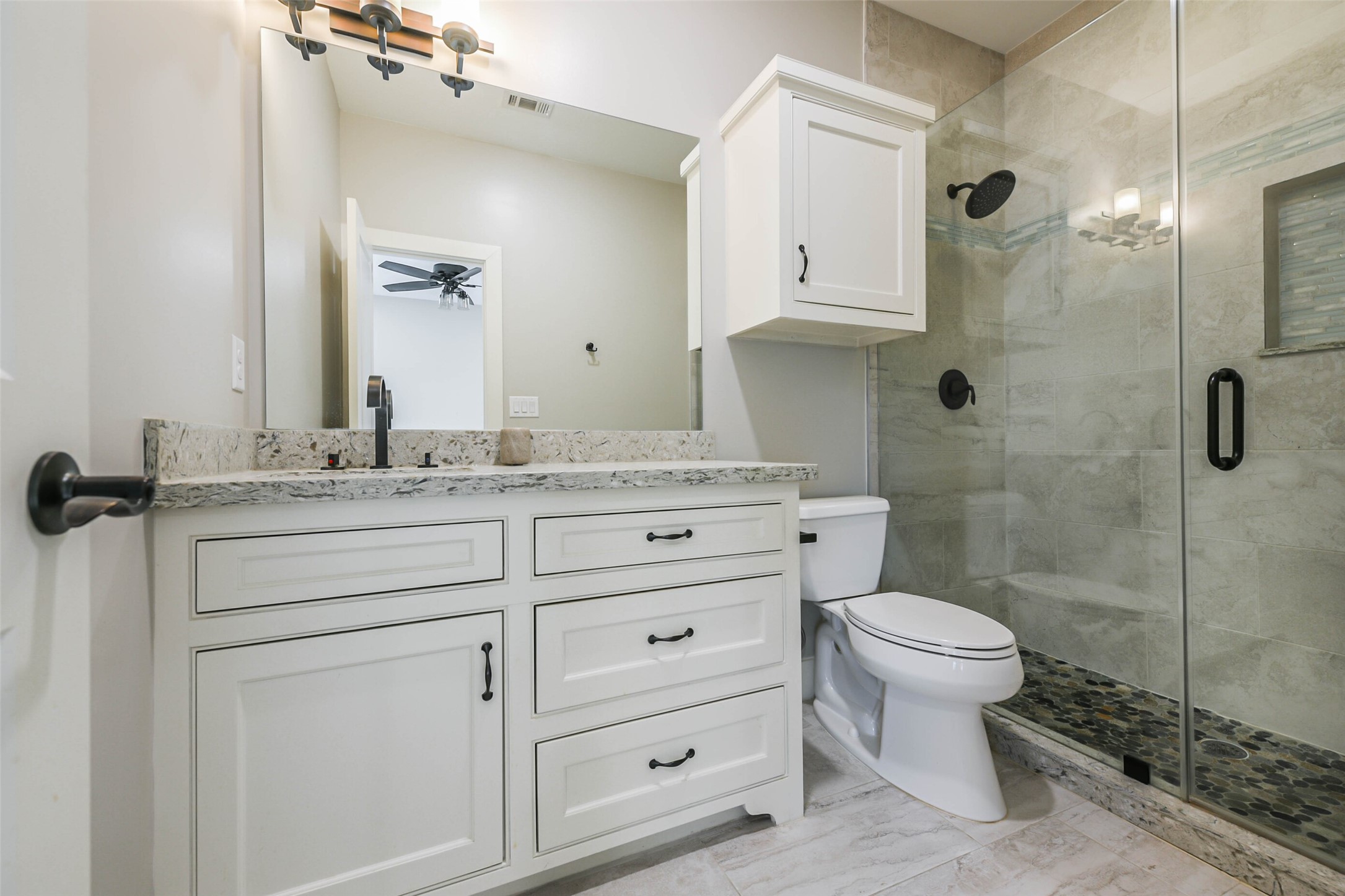 2422 Hadley Street Houston, TX 77004 - Photo 42 of 50 a bathroom with a granite countertop sink toilet and shower