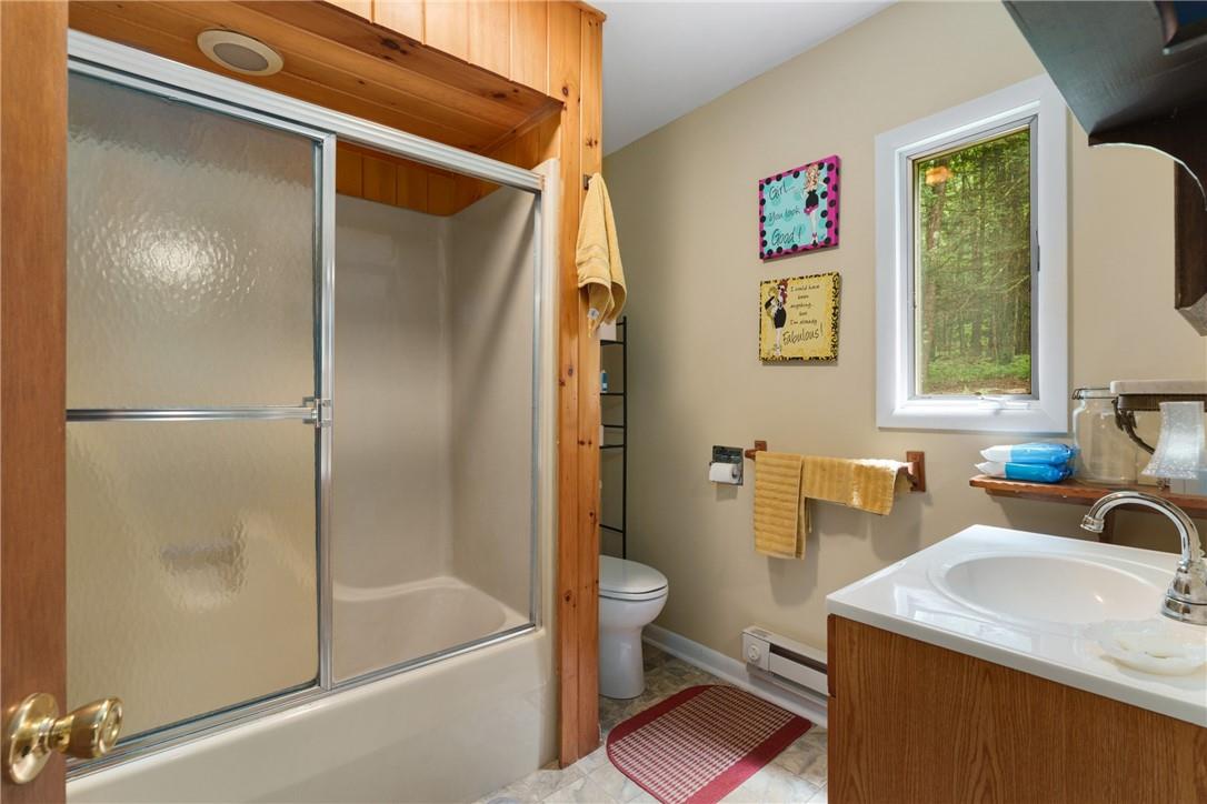 47 Johns Road Cochecton, NY 12726 - Photo 15 of 28 Full bathroom with combined bath / shower with glass door, tile floors, a baseboard radiator, toilet, and vanity