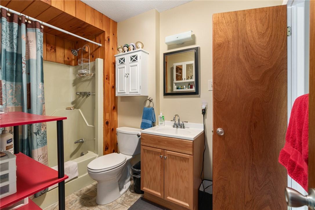47 Johns Road Cochecton, NY 12726 - Photo 21 of 28 Full bathroom with a textured ceiling, vanity with extensive cabinet space, toilet, and shower / bathtub combination with curtain