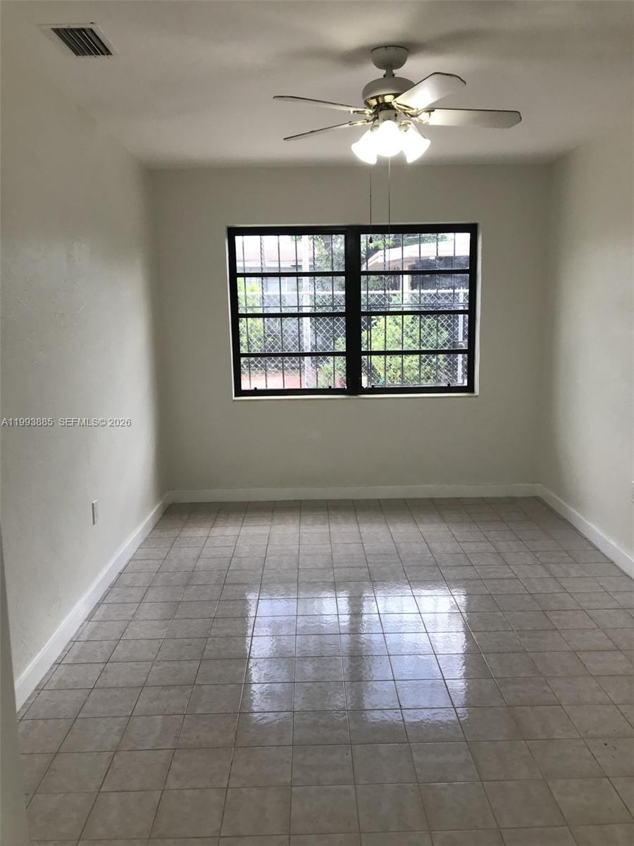 2362 Northwest 34th Street, Unit 2 Miami, FL 33142 - Photo 4 of 8 wooden floor in an empty room with a window