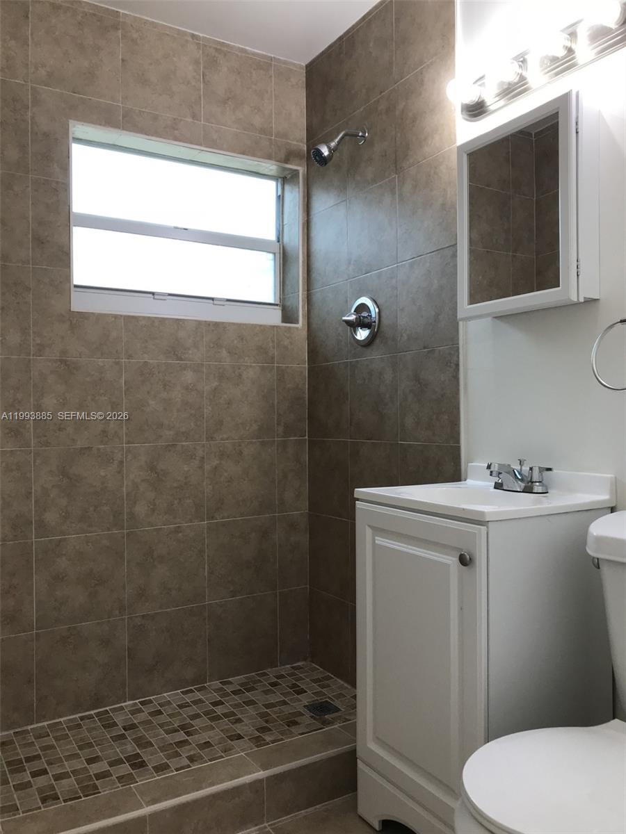 2362 Northwest 34th Street, Unit 2 Miami, FL 33142 - Photo 5 of 8 a bathroom with a sink a toilet and shower