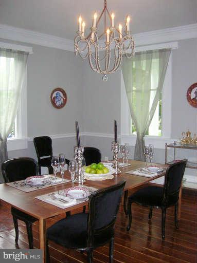 1708 Mansion Ridge Road Annapolis, MD 21401 - Photo 14 of 30 a view of a dining room with furniture a chandelier and wooden floor