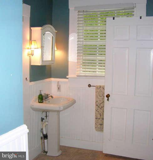 1708 Mansion Ridge Road Annapolis, MD 21401 - Photo 20 of 30 a bathroom with a sink a mirror and a window