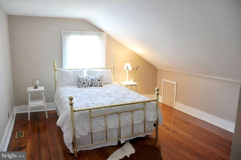 1708 Mansion Ridge Road Annapolis, MD 21401 - Photo 24 of 30 a bedroom with a bed and a table