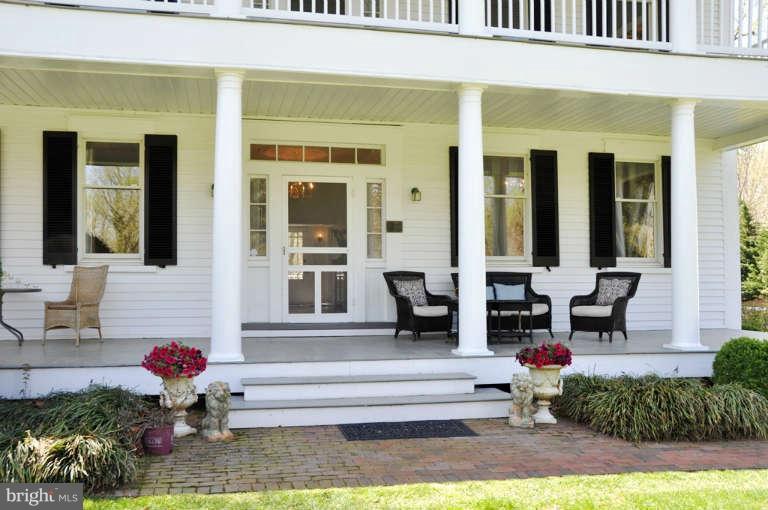 1708 Mansion Ridge Road Annapolis, MD 21401 - Photo 5 of 30 a front view of a house with a yard and potted plants