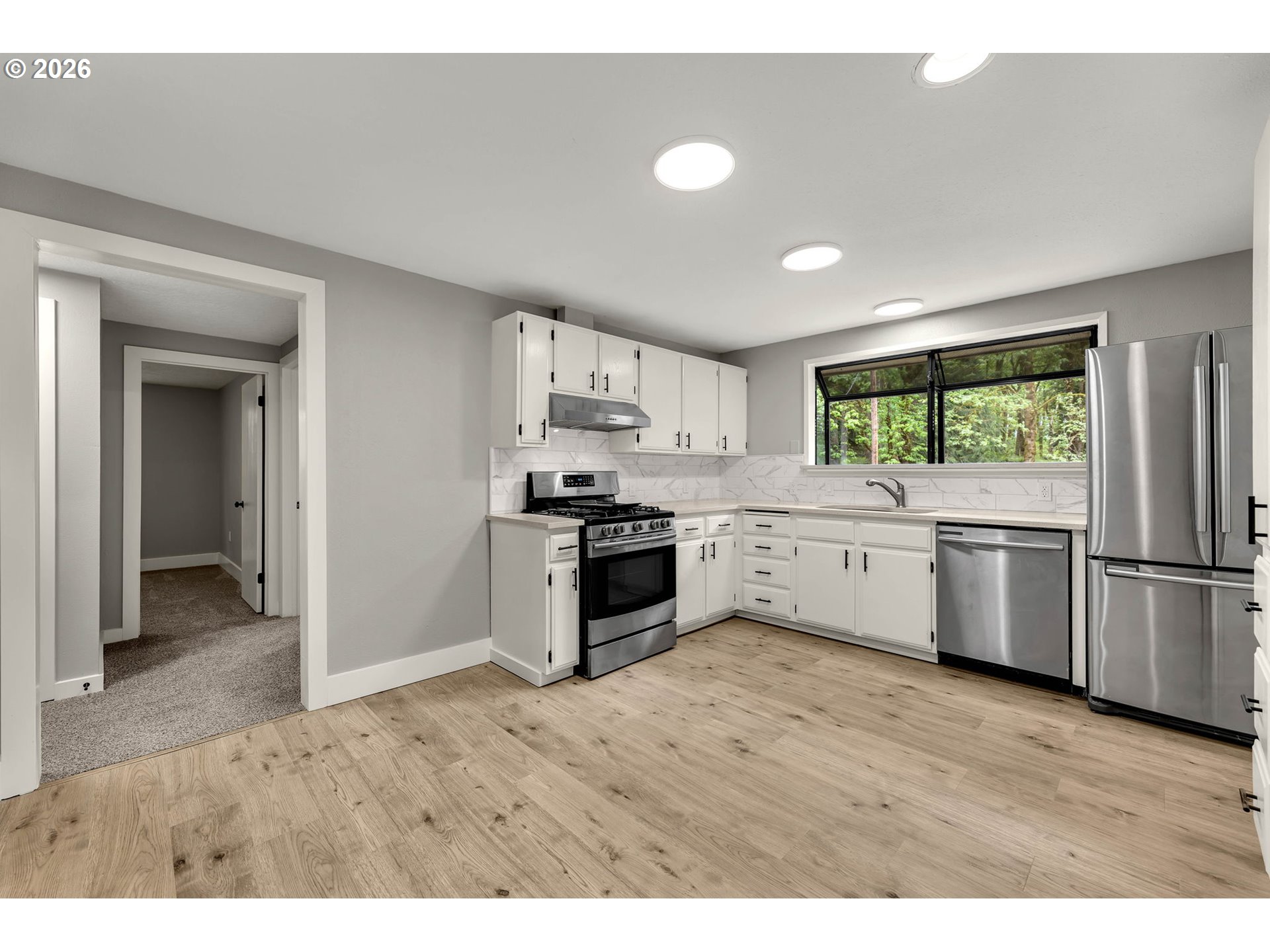 30921 Northwest Spencer Road La Center, WA 98642 - Photo 10 of 39 a kitchen with a white cabinets and white appliances