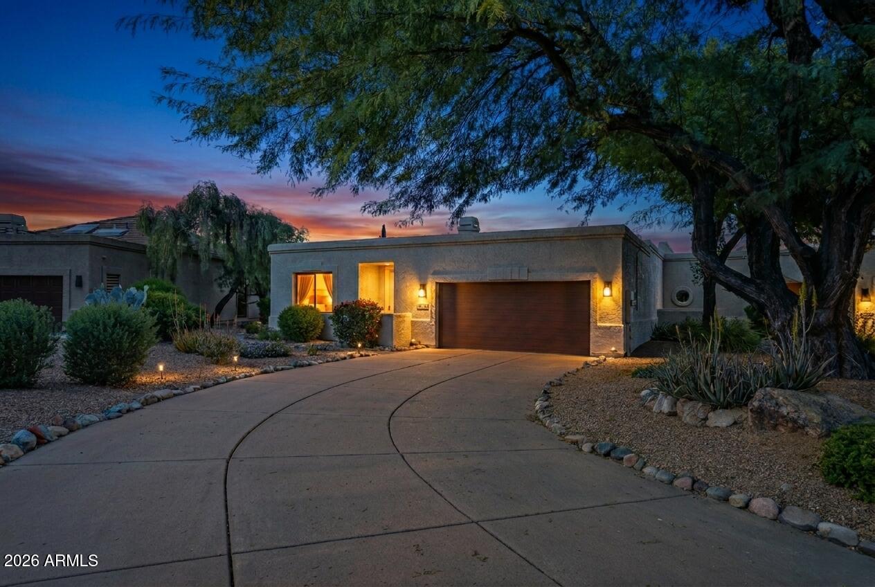 a front view of a house with yard and outdoor seating