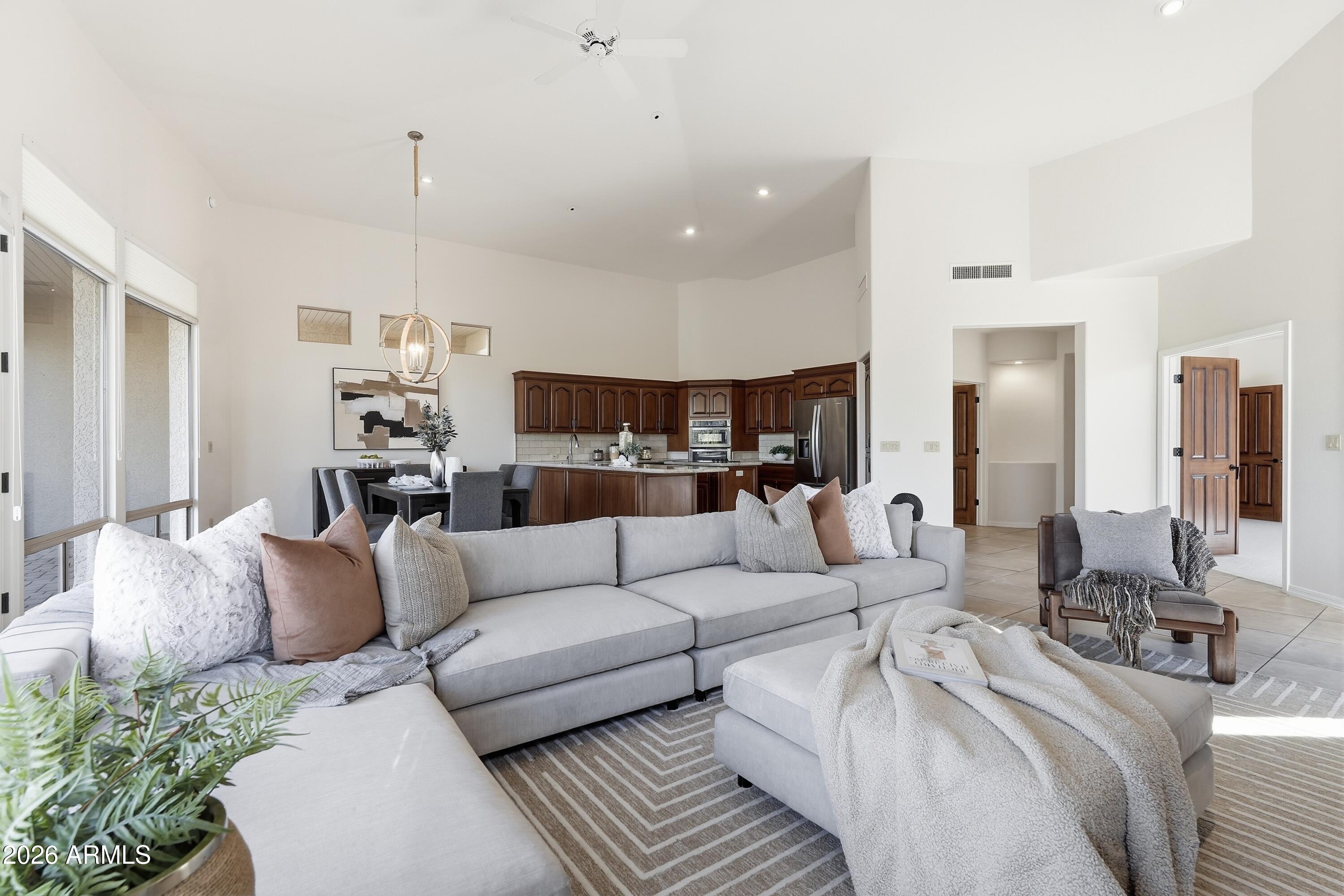 18602 Amarado Circle Rio Verde, AZ 85263 - Photo 11 of 58 a living room with furniture kitchen view and a chandelier