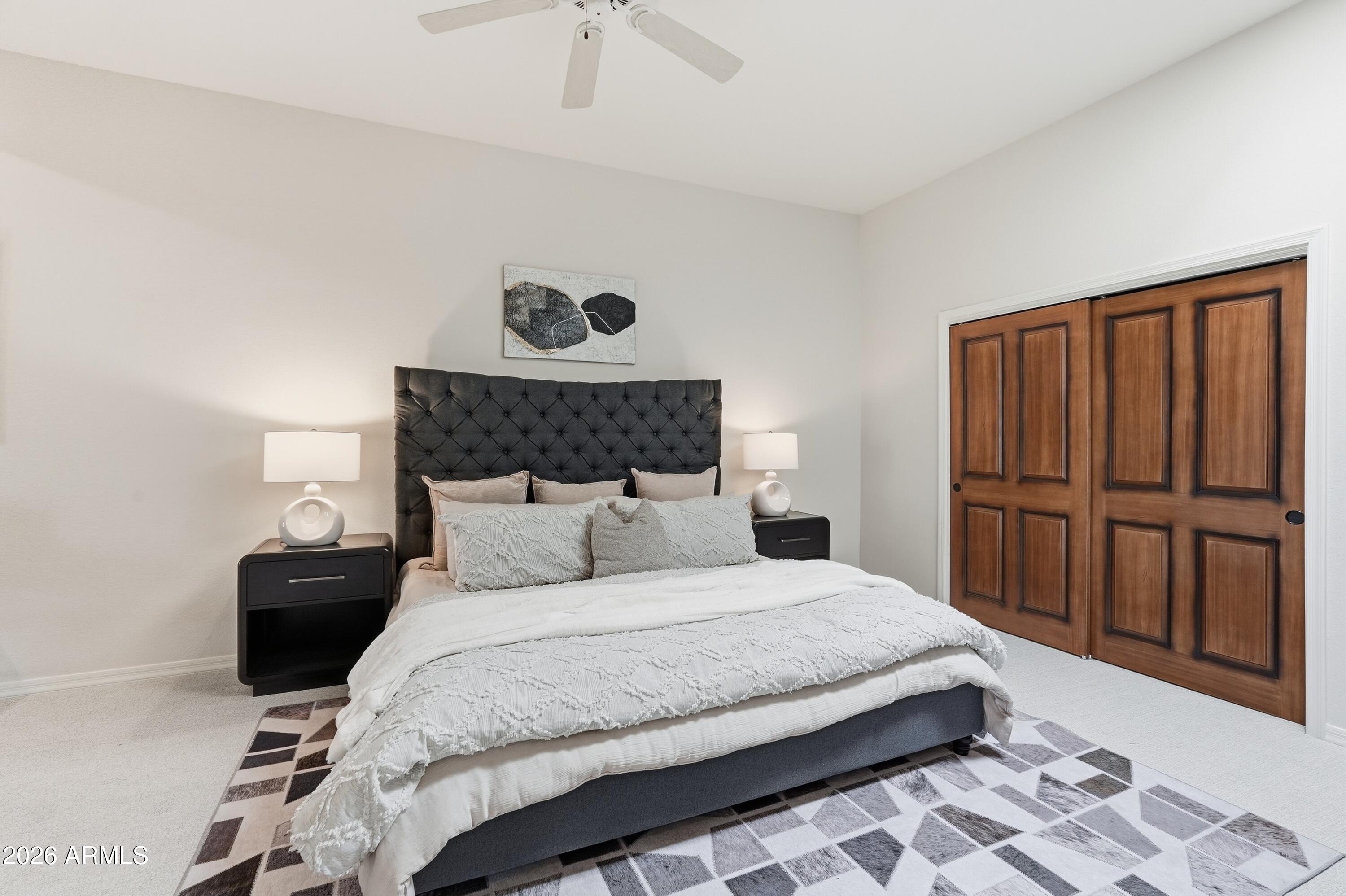 18602 Amarado Circle Rio Verde, AZ 85263 - Photo 17 of 58 a bedroom with a bed and wooden floor