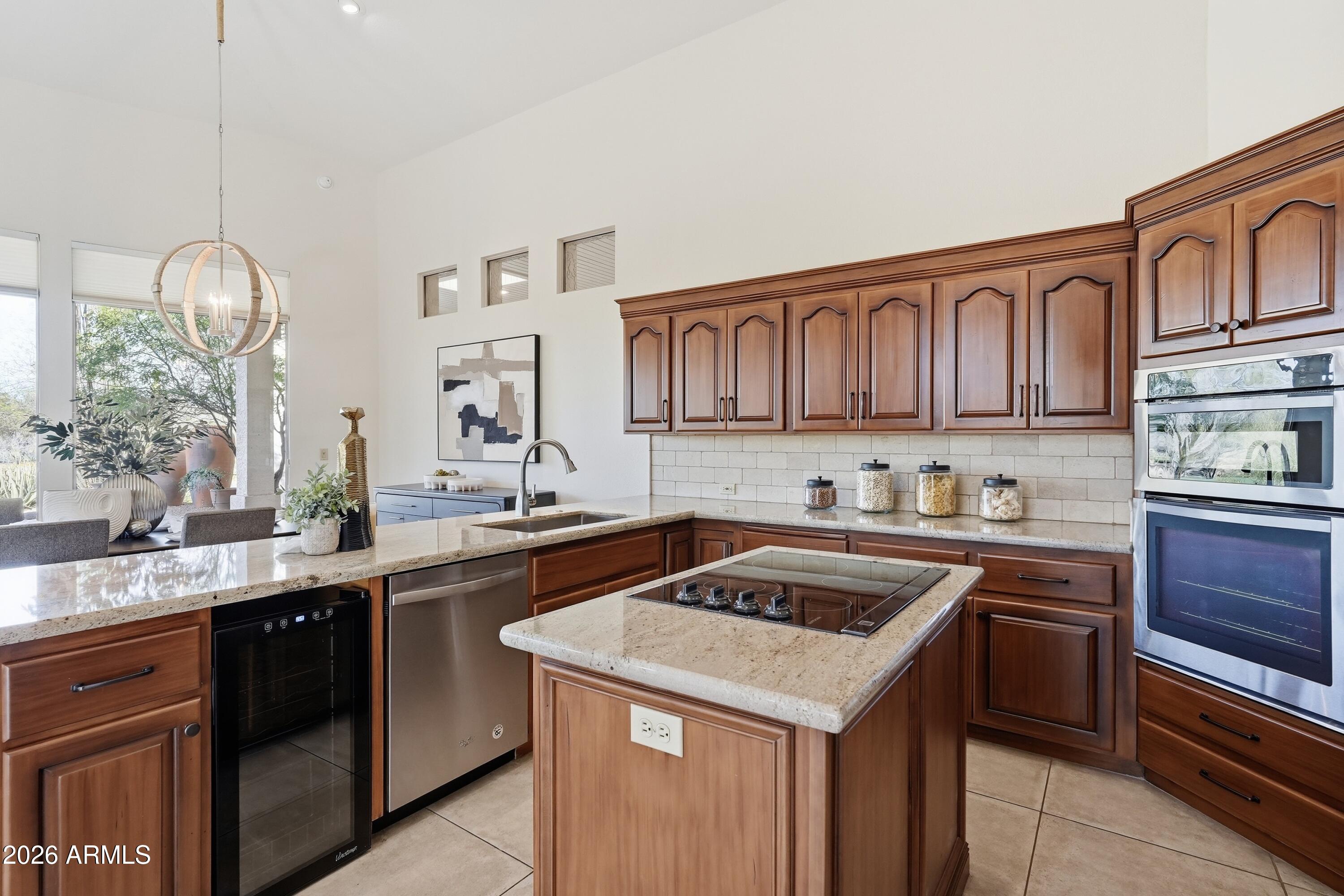 18602 Amarado Circle Rio Verde, AZ 85263 - Photo 6 of 58 a kitchen with a sink a stove and cabinets